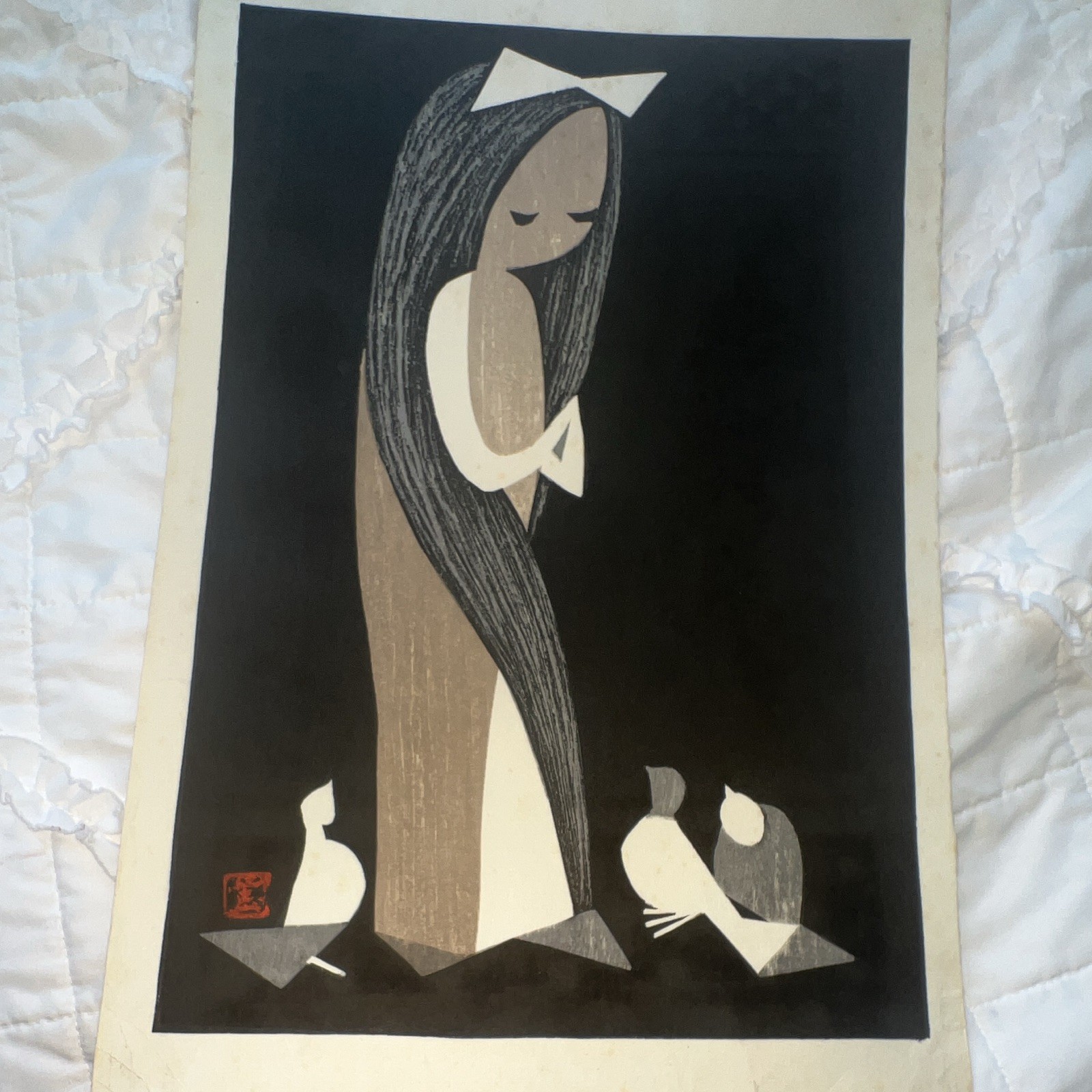 A framed Japanese woodblock print by Kaoru Kawano titled “Girl with Doves.”